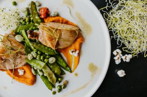 een bord met eten met vlees en groenten op een tafel bij Villa Saltic in Grzybowo