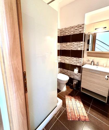 a bathroom with a toilet and a sink at Villa Papagiorgio Luxury and Harmony in Gennadi