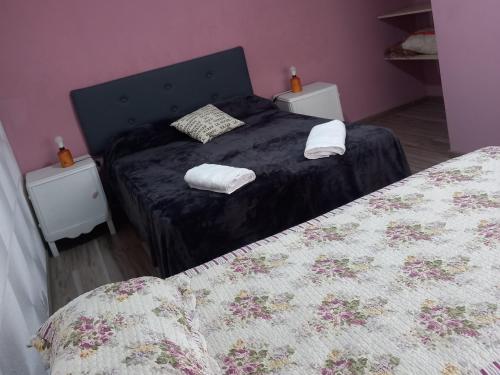 a bedroom with two beds and two night stands at Casa Dora in Olavarría