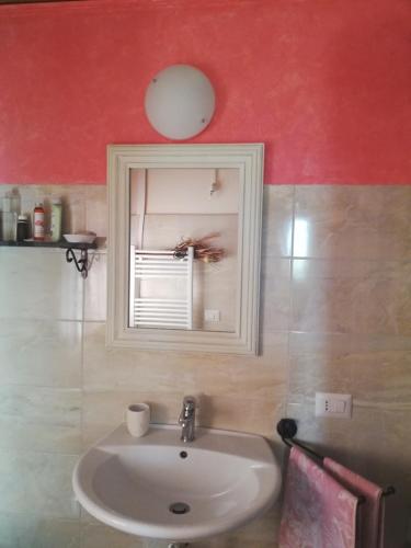 a bathroom with a white sink and a window at Insula -- Telti in Telti