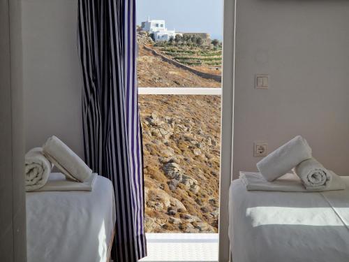 a room with two beds and a window with a view at Fanari sea view studios in Fanari