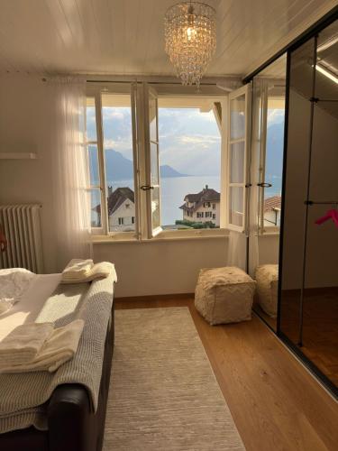 a bedroom with a bed and a large window at Villa Montreux in Montreux