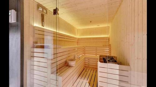 a sauna with a toilet in a wooden room at Motlawa Inn Apartment-Suna,Gym&Parking in Gdańsk