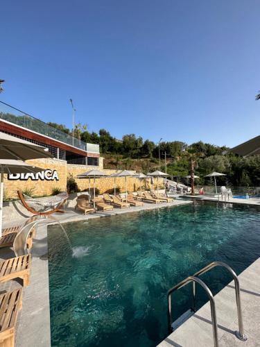 a swimming pool with lounge chairs and a swimming pool at Bianca Hotel & Villa in Tirana