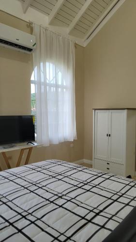 a large bed in a room with a large window at The Perfect Spot in Falmouth