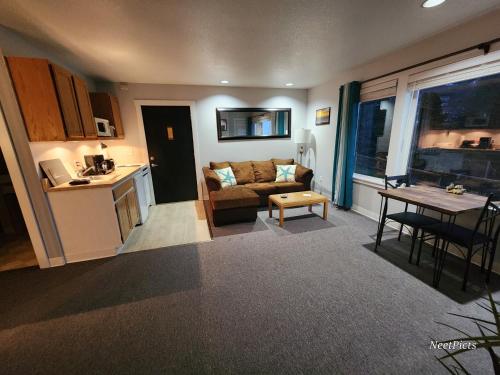 a living room with a couch and a table at Inn at Arch Rock in Depoe Bay