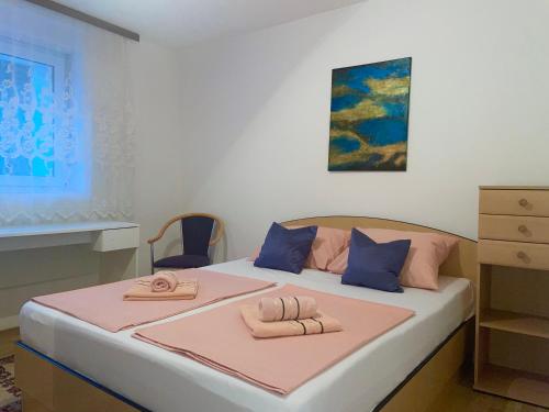 a bedroom with a bed with two towels on it at MFS Apartments in Mostar
