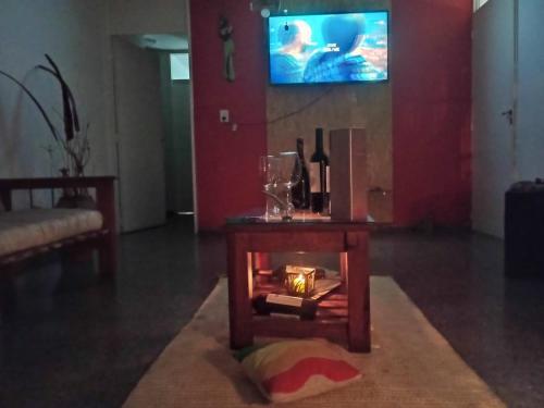a living room with a table and a tv at Hostel AGUS !!! in Guaymallen