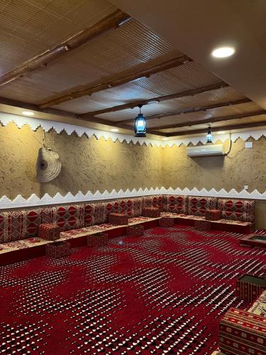 a large room with a large red floor in a building at استراحة الورود in Tanomah
