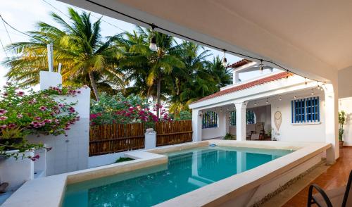 a swimming pool in the backyard of a house at Beach house in Chuburná