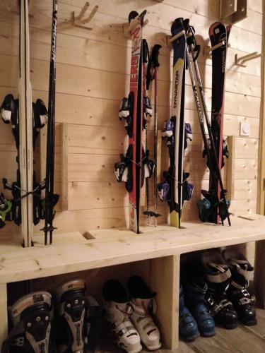 a bunch of skis and snowboards on a shelf at Chalet classé 5 étoiles avec bain nordique entièrement neuf in Luz-Saint-Sauveur