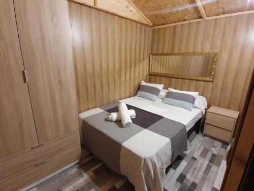 a bedroom with a bed with a teddy bear on it at La chocita de Tortosa in Tortosa