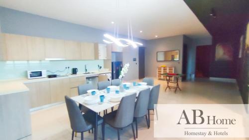 a kitchen and a dining room with a table and chairs at ABHOME "ART MUSEUM SUITE" #GreenHaven #360"City & Sea View #Masai #JB in Johor Bahru