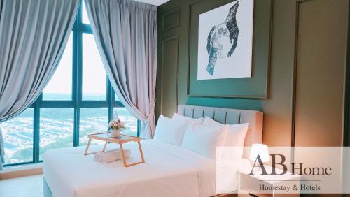 a bedroom with a bed with a table and a window at ABHOME "ART MUSEUM SUITE" #GreenHaven #360"City & Sea View #Masai #JB in Johor Bahru
