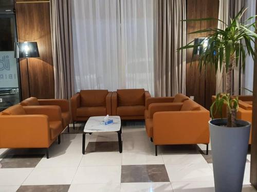 a waiting room with orange couches and a table at IBIRIS in Oran