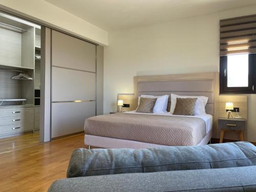 a bedroom with two beds and a couch at PENEMA VILLA in Hersonissos