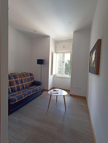 a living room with a couch and a table at FAMILY Apartamento I in Coimbra