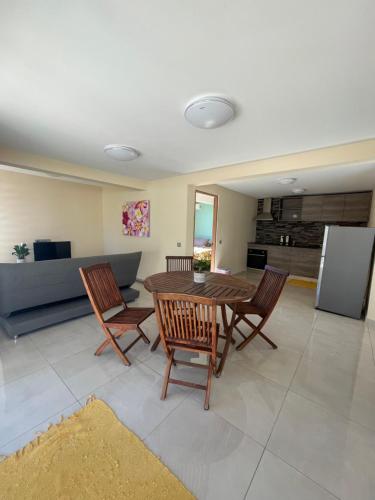 a kitchen and dining room with a table and chairs at Auae hills lodge in Faaa