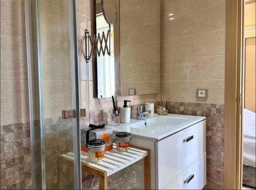 a bathroom with a sink and a mirror at Cosy Apartment with sea view in Sidi Rahal