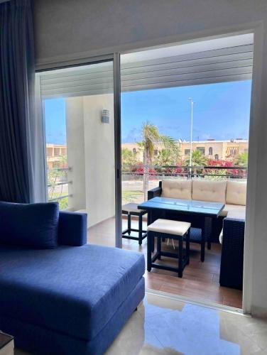 a living room with a couch and a table at Cosy Apartment with sea view in Sidi Rahal