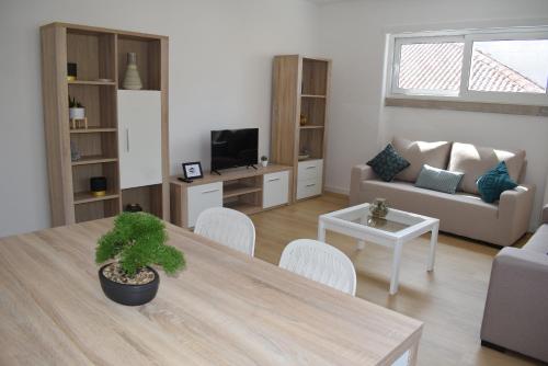 a living room with a table and a couch at Conchada House 13 in Coimbra