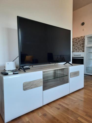 a large white entertainment center with a large television on it at Apartment Čapljina in Čapljina