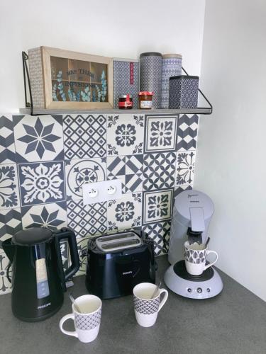 a kitchen with two cups of coffee on a counter at A&J Studio - Bonny sur Loire -Châteaux de Guedelon- Pont Canal in Bonny-sur-Loire