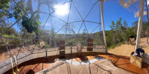 a glass dome with an owl sitting on a table at Herdade da Maceira in São Luis