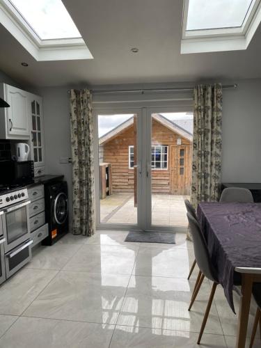 a kitchen with a dining table and a sliding glass door at Sligo town House in Sligo