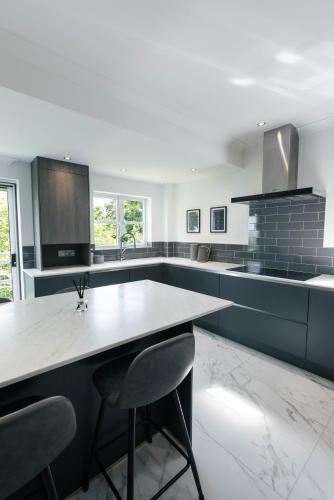 a kitchen with a table and two chairs in it at Harbour House in Plymouth