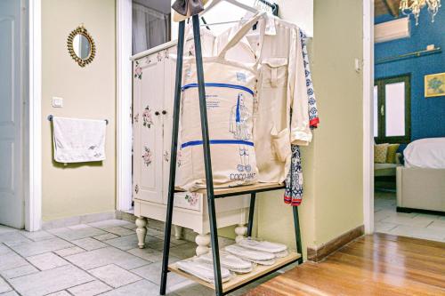 a clothes rack with a shirt on it in a room at Via Porta Raimonda (Luxury central detached house) in Corfu