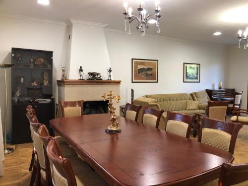a dining room with a table and a fireplace at Armenia villa Jrvezh in Dzoraghpʼyur