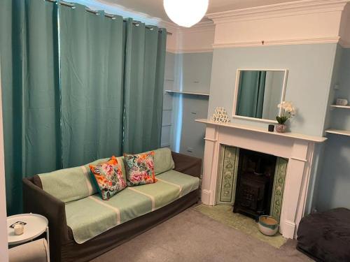 a living room with a couch and a fireplace at Knavesmire in York
