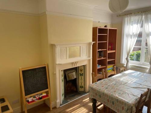 a dining room with a table and a fireplace at Knavesmire in York