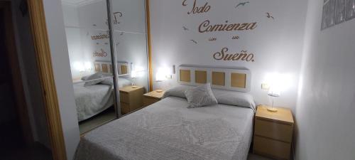 - une petite chambre avec un lit et un miroir dans l'établissement ALIRE YUCAS, à Fuengirola