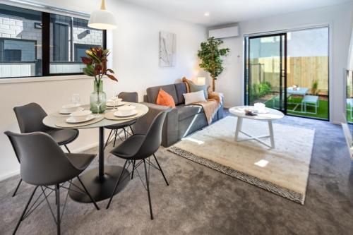 a living room with a table and chairs and a couch at Haven near Hagley Park, Hospital, Parakiore, Avon in Christchurch