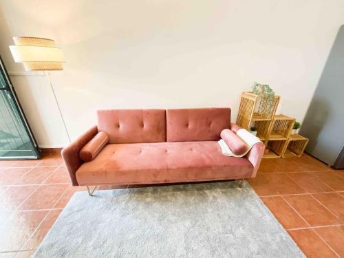 a brown leather couch in a living room with a rug at Beautiful Apartment near Carcavelos Beach in Parede