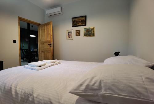 a bedroom with a white bed with towels on it at Agroturystyka Lesieniec - Magdalena i Maciej Mochoń in Syców