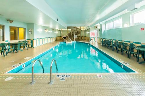 a large swimming pool with a person swimming in it at Comfort Inn & Suites in Salmon Arm