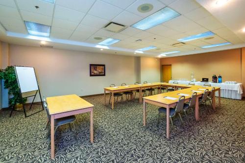 a conference room with tables and chairs and a whiteboard at Comfort Inn & Suites in Salmon Arm