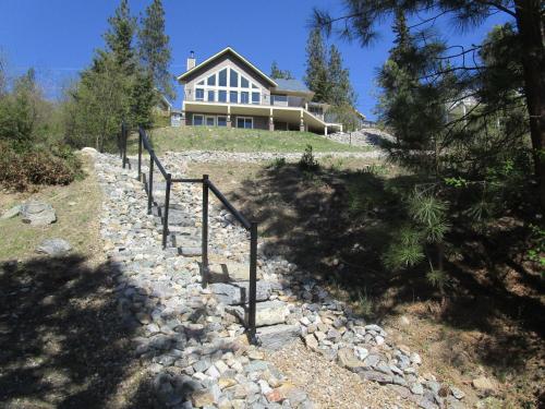 a house on top of a hill with a stone path at Okanagan Lake Sunrise BB in Vernon