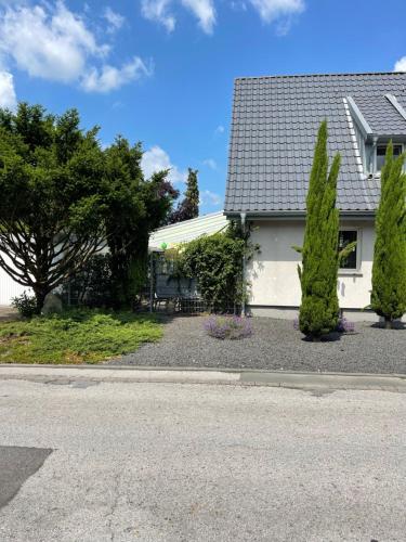 a white house with two trees in front of it at Caros Zimmer Gladbeck in Gladbeck