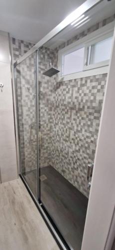 a shower with a glass door in a bathroom at A Casa de Meli in Muros