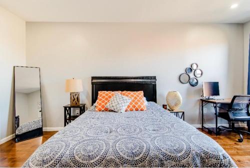 a bedroom with a bed with orange pillows and a mirror at Downtown Shared Apartment in Providence