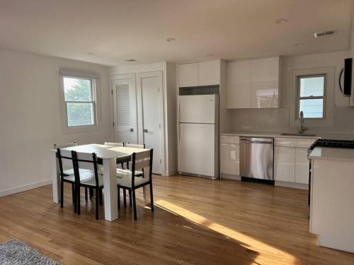 a kitchen with a table and chairs in a room at Relax & Recharge At The Sea in Long Branch