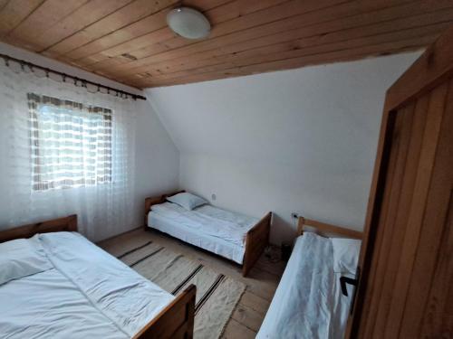 ein kleines Zimmer mit 2 Betten und einem Fenster in der Unterkunft Stara kuca u Virku in Žabljak