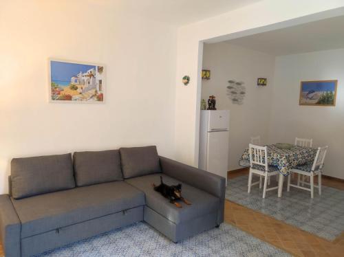a living room with a couch and a table at Casa Porto Palo in Porto Palo