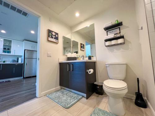 a bathroom with a toilet and a counter with a sink at Luxury Downtown Los Angeles Penthouse Condo with Skyline Views in Los Angeles