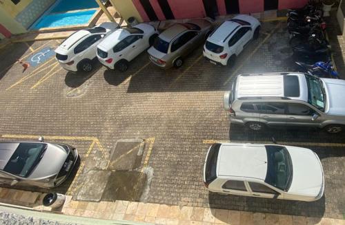 a group of cars parked in a parking lot at Apartamento Porto das Dunas in Aquiraz