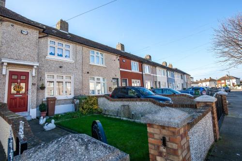 a house with a yard with cars parked in front of it at Rainbow Heights Dublin in Dublin